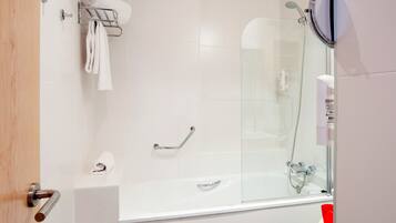 A modern bathroom with a glass-enclosed shower, a white bathtub, and a towel rack.