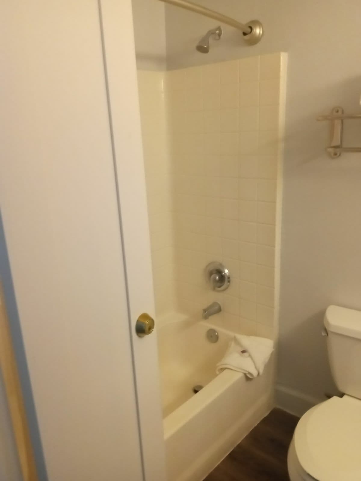 A bathroom with a bathtub, toilet, and a shower.