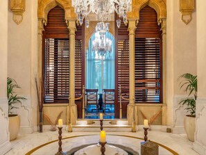 A grand hall with a central arched window, chandeliers, and a marble floor. - Mövenpick Hotel Al Khobar (Al Khobar)