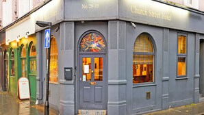 A corner building with a sign reading "Church Street Hotel" and a door with a colorful glass window. - Church Street Hotel by Belvilla near Kings College Hospital (London)