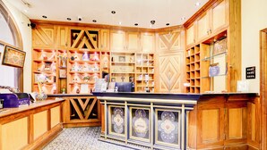 A reception area with wooden cabinets, a counter, and a tiled floor. - Church Street Hotel by Belvilla near Kings College Hospital (London)