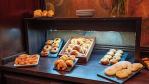 A bakery display with various pastries and bread.