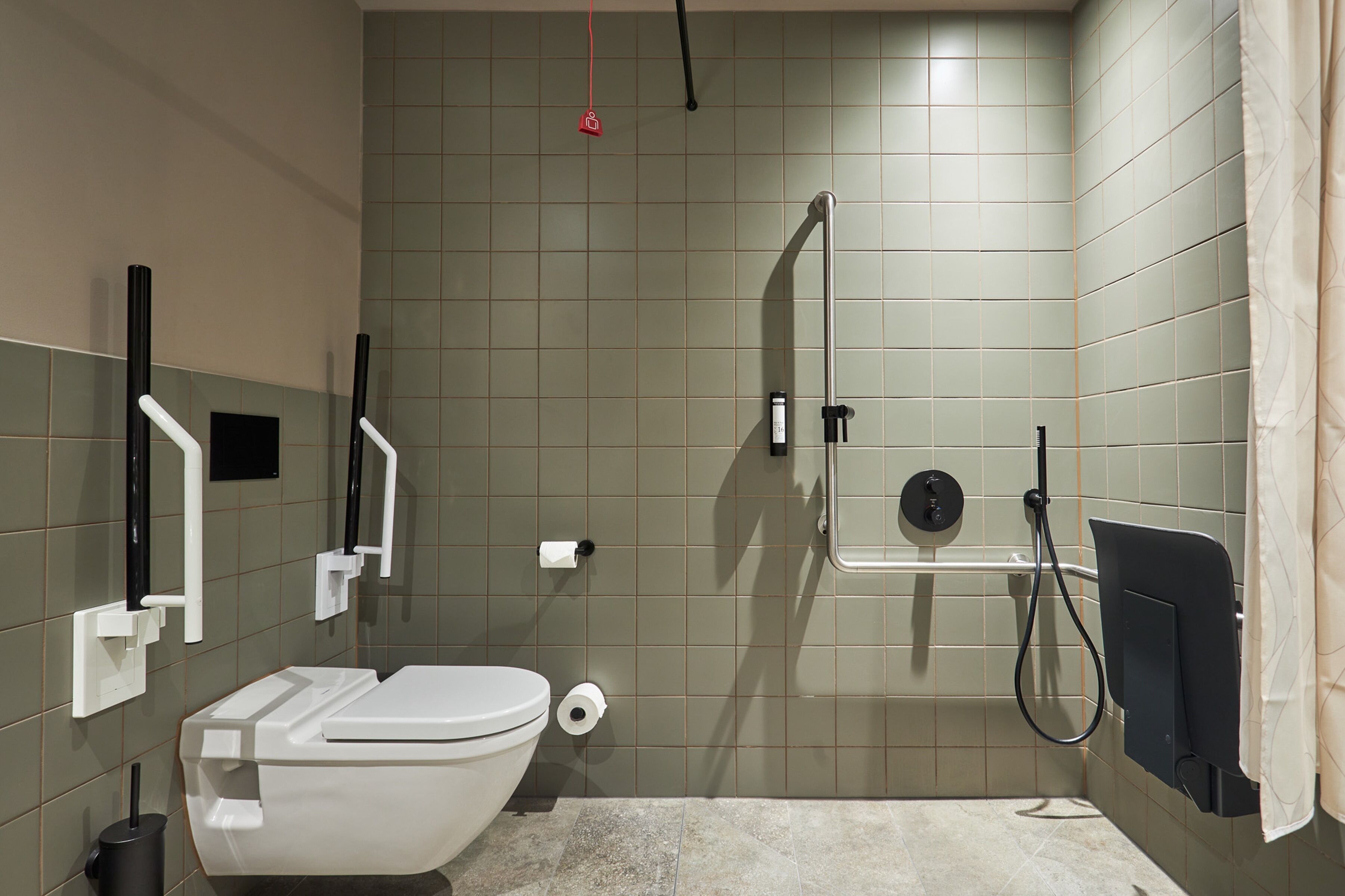 A modern bathroom with a toilet, bidet, and shower.
