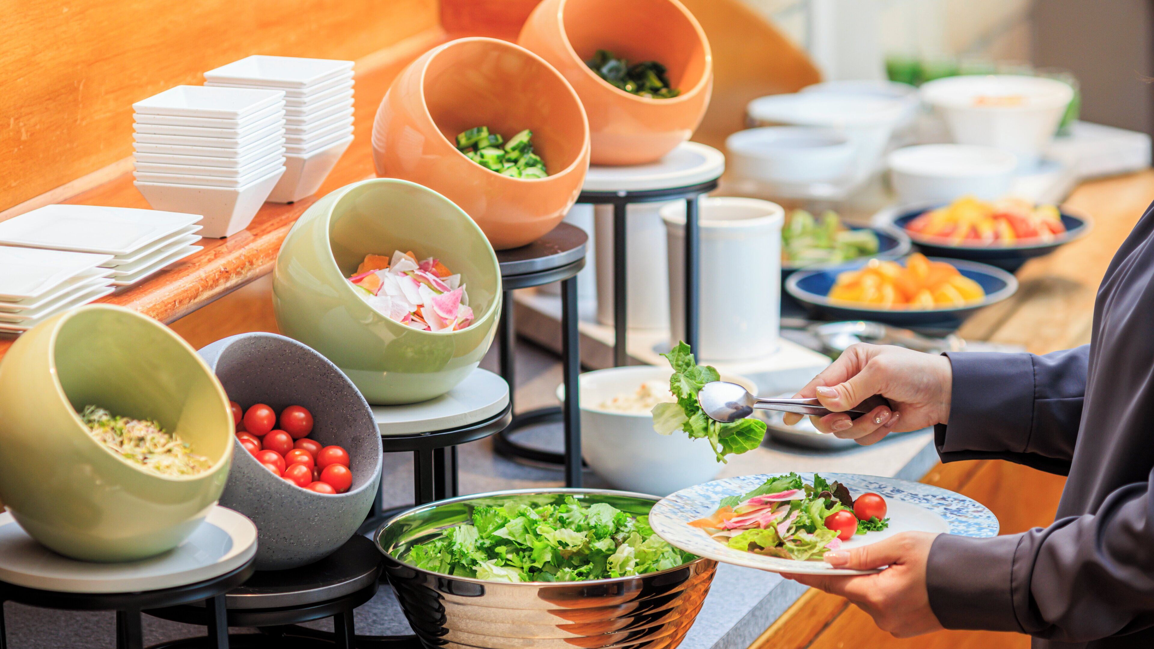 A buffet setup with various food items and bowls.