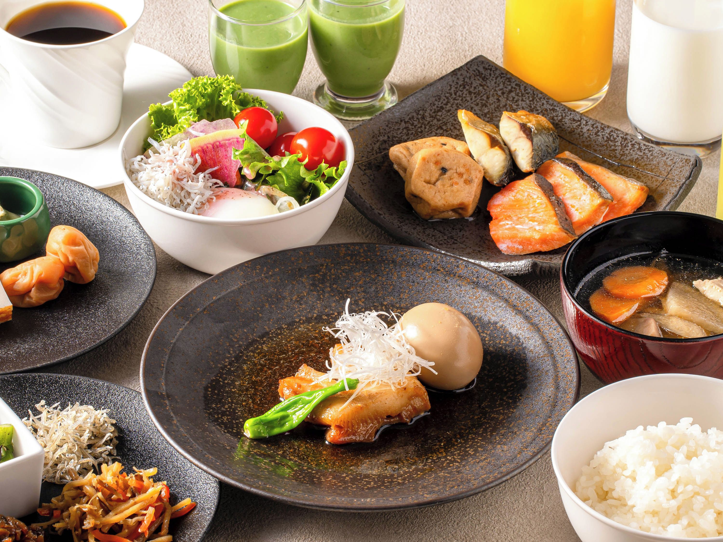 A variety of dishes including sushi, rice, and vegetables, suggesting a meal setting.