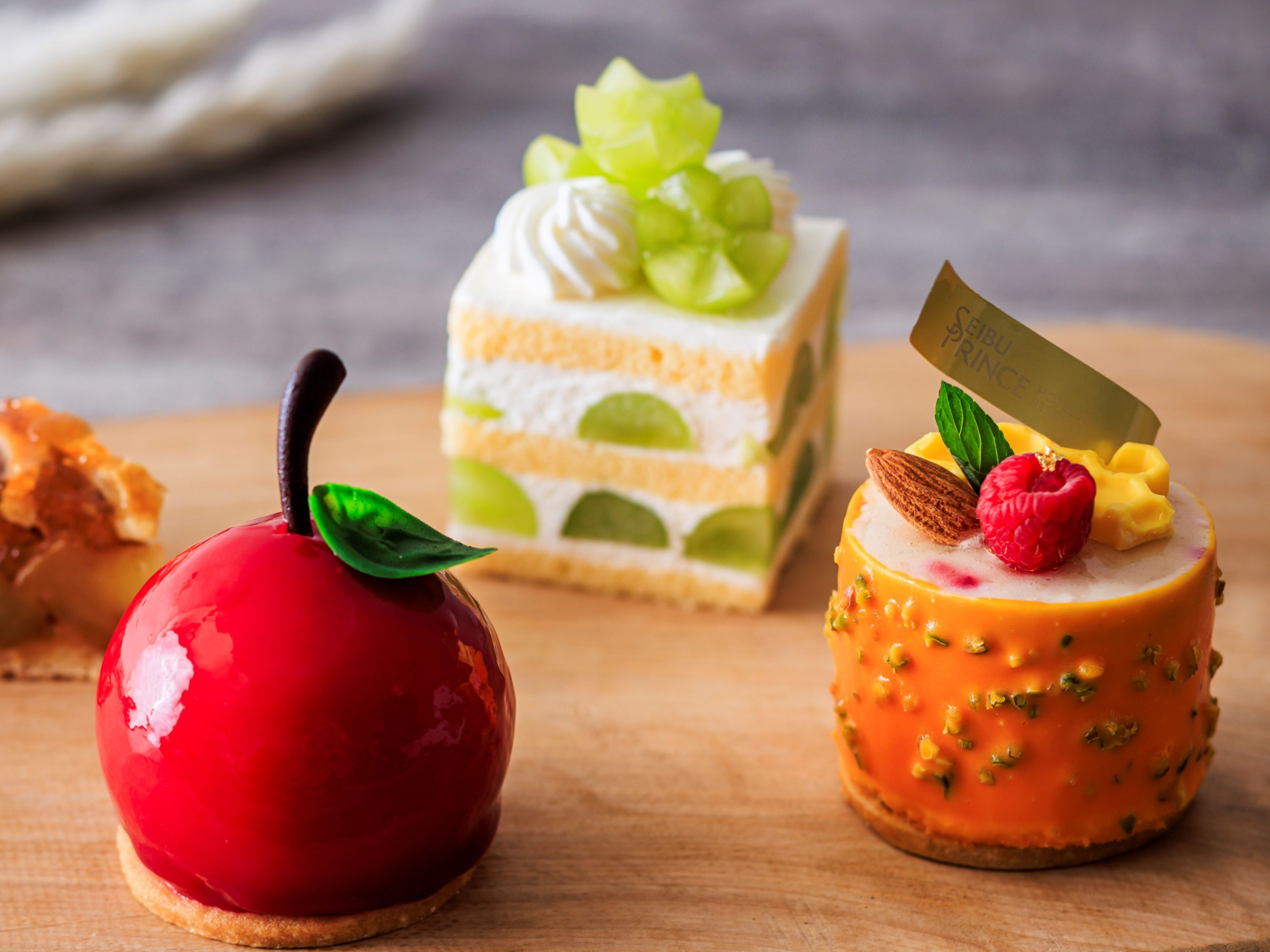 Three desserts on a wooden surface.