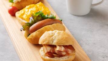 A wooden board with sandwiches and a cup of coffee.