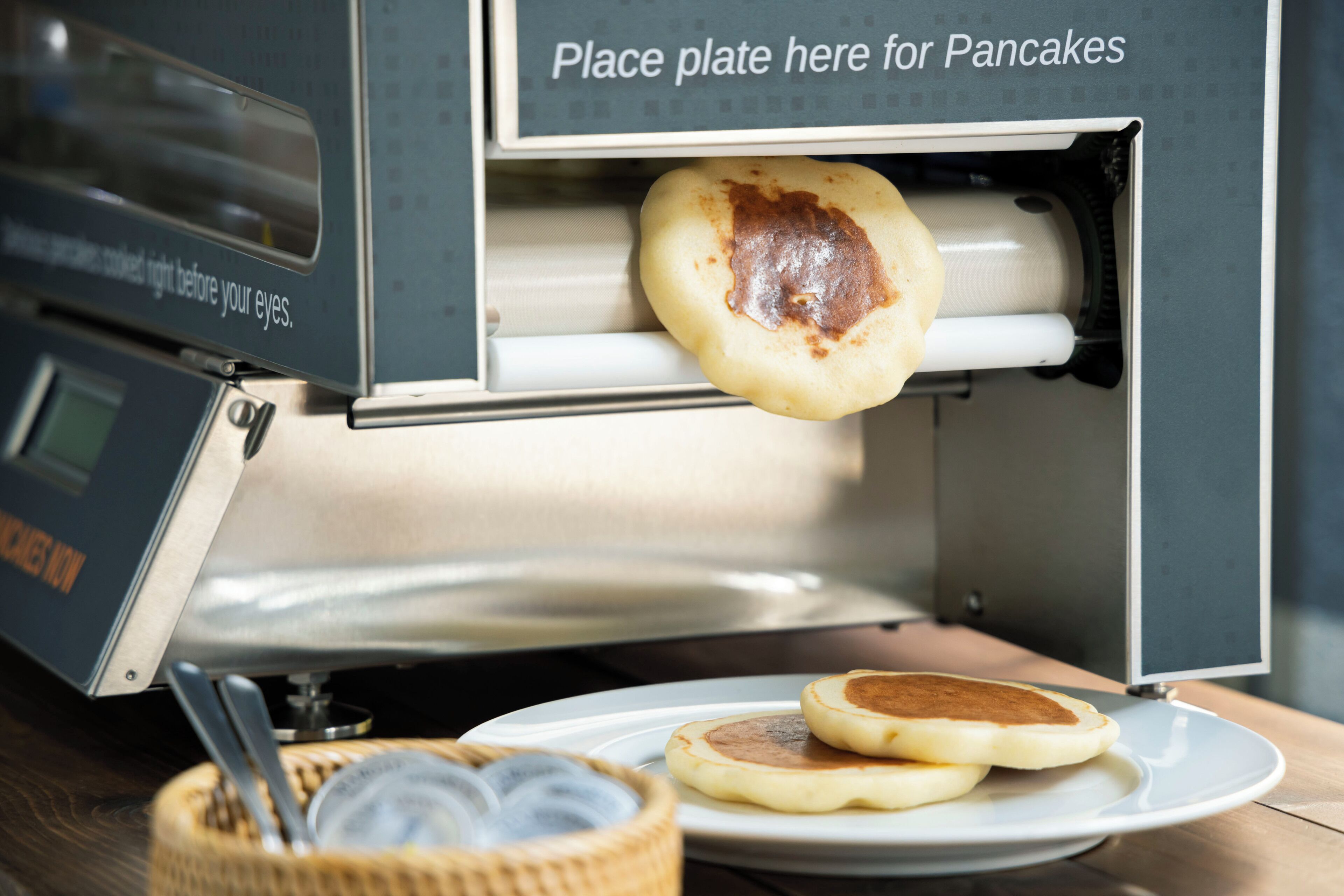 A breakfast setting with a waffle maker and a plate for pancakes.