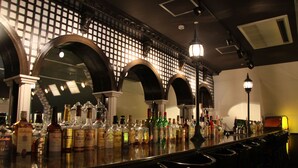 A bar with multiple liquor bottles and a bar counter. - the b hachioji (Hachioji)