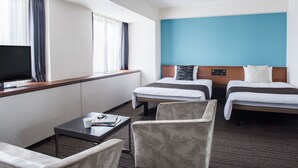A hotel room with two beds, a TV, a coffee table, and a seating area. - the b hachioji (Hachioji)