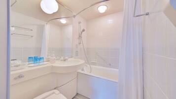 A modern bathroom with a bathtub, a sink, and a toilet.