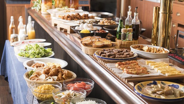 A buffet with various food items and condiments. - the b kobe (Kobe)