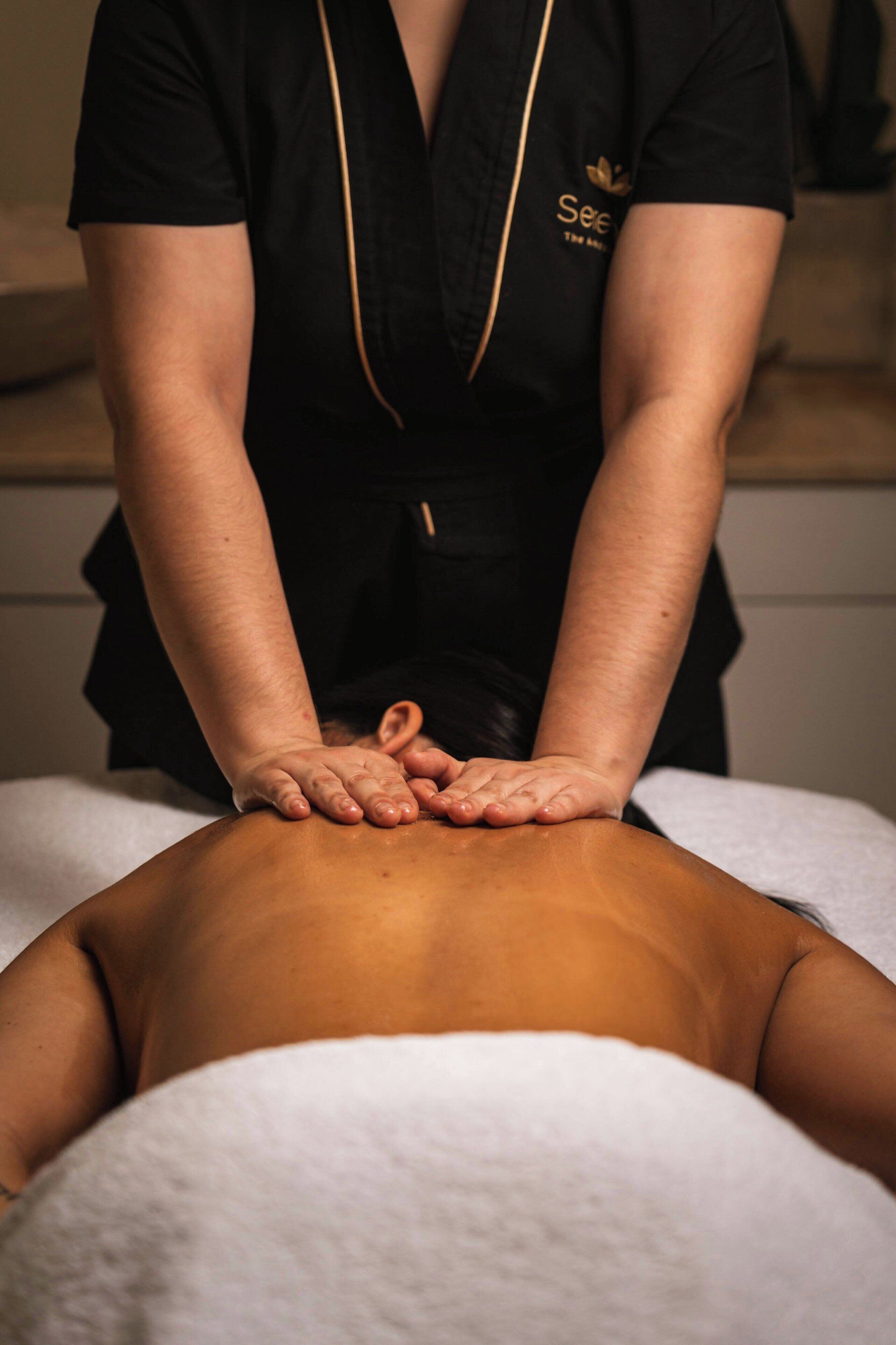 A person receiving a back massage.