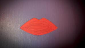A red painted lips shape on a dark surface. - Il Giglio Rosso - B&B (Florence)