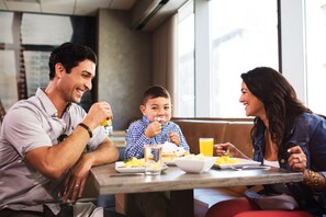 Enjoy a family meal in a comfortable dining space with booths and tables.