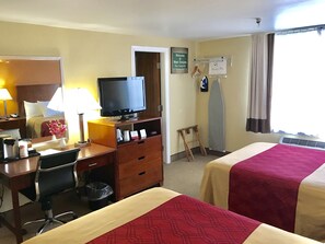 A hotel room with two beds, a desk with a computer, a television, and a mirror. - Econo Lodge Lake Region (West Ossipee)