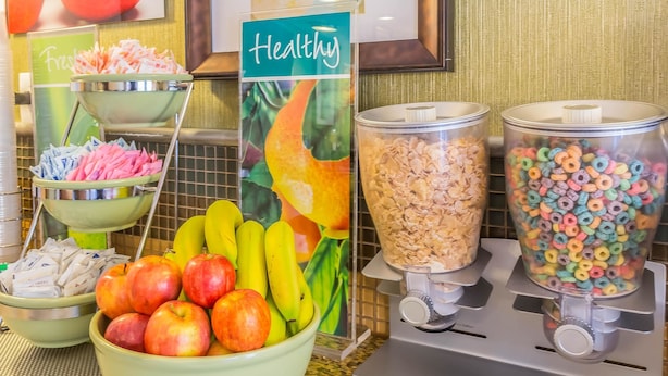 A breakfast buffet with fresh fruits, cereal, and snacks. - Quality Inn Flamingo (Atlantic City)