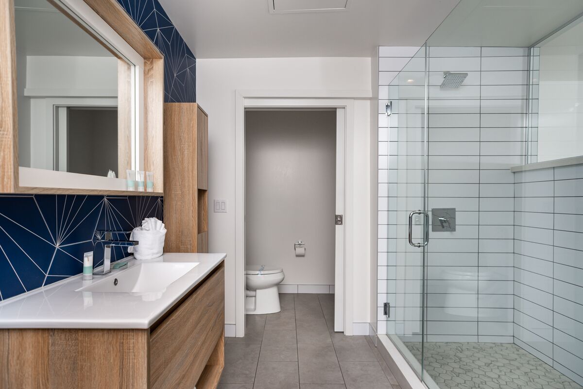 luxury studio suite | bathroom | shower, designer toiletries, hair dryer, towels