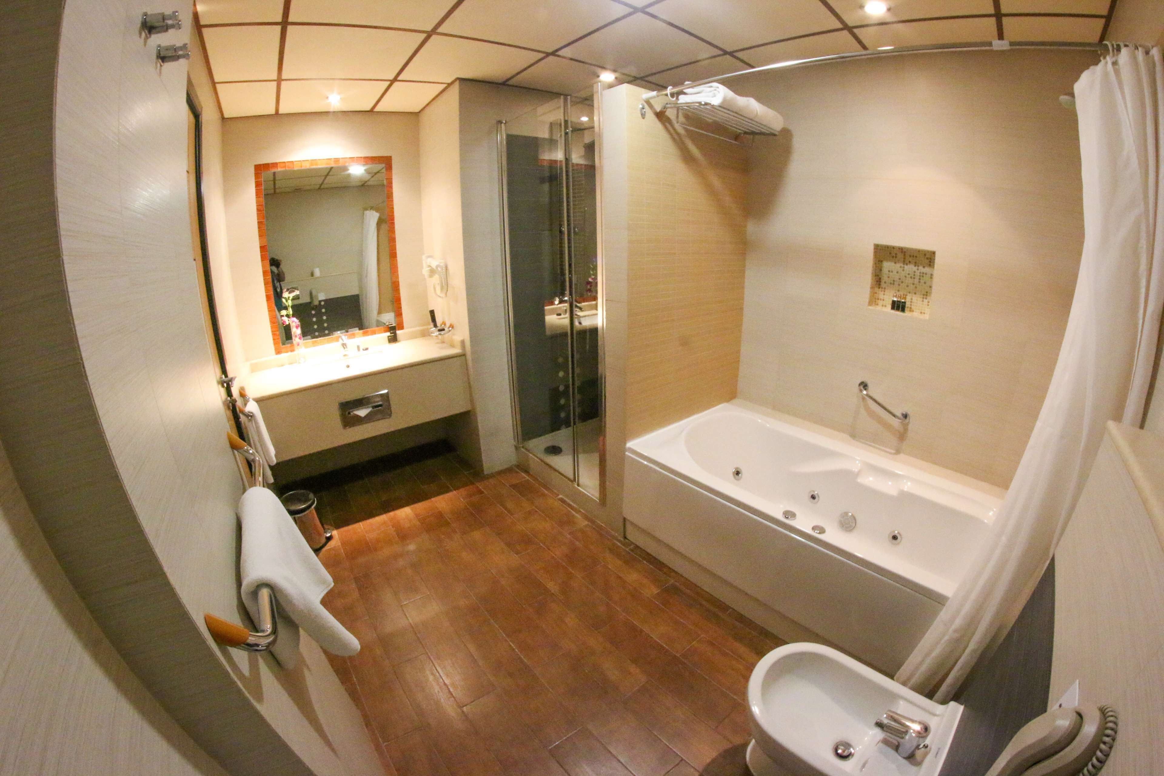 Ein Badezimmer mit Duschkabine, Badewanne, Waschbecken und Toilette.