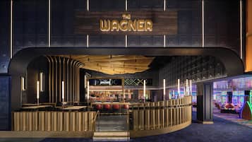 A bar area with a sign reading 'The Wagner' and a bar counter with stools.