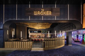 A bar area with a sign reading 'The Wagner' and a bar counter with stools.