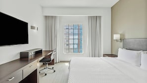 A hotel room with a bed, a desk, a TV, a window with curtains, and a nightstand. - Fiesta Inn Express Ciudad Obregón (Cajeme)