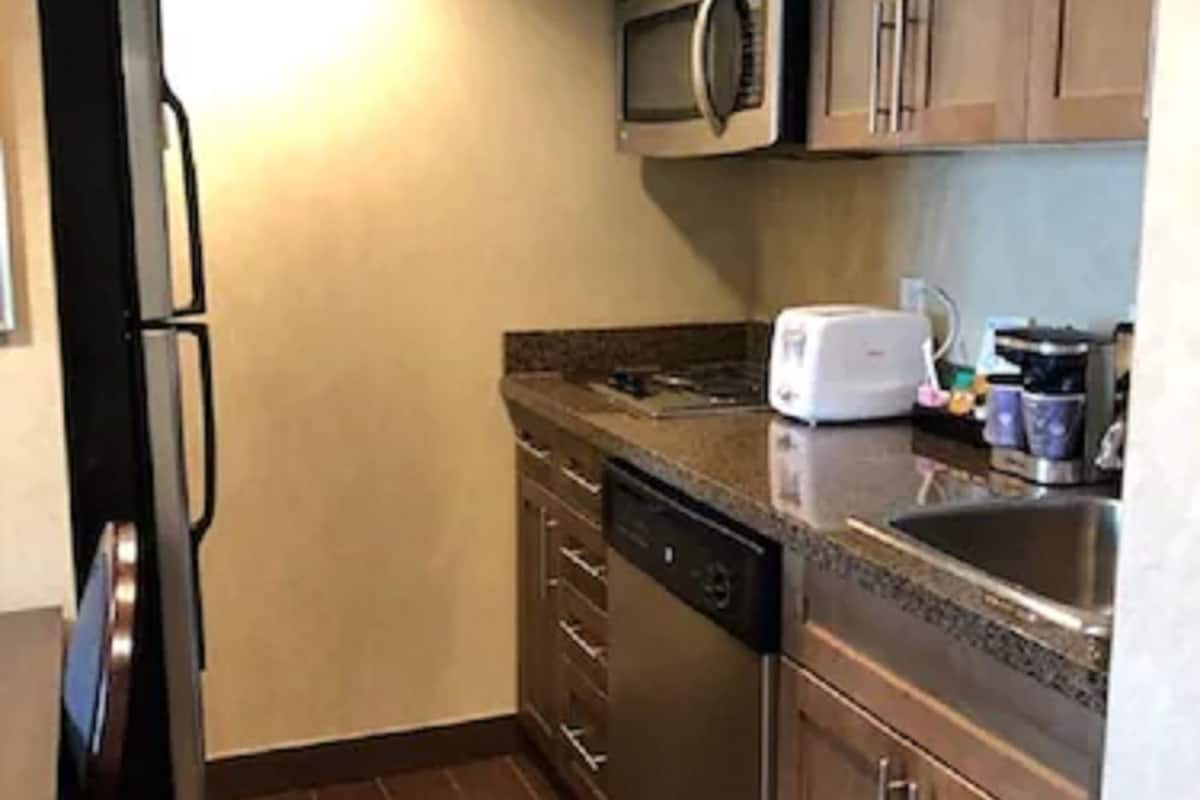full-sized fridge, microwave, cookware/dishes/utensils