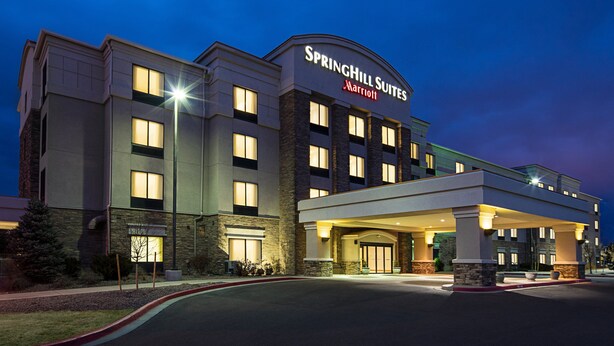 A SpringHill Suites hotel with a modern design, featuring a prominent entrance and multiple windows. - SpringHill Suites by Marriott Denver Airport (Denver)