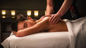 Experience a rejuvenating massage on a comfortable table, with a skilled practitioner providing expert care.