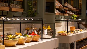 A buffet setup with various food items and beverages.