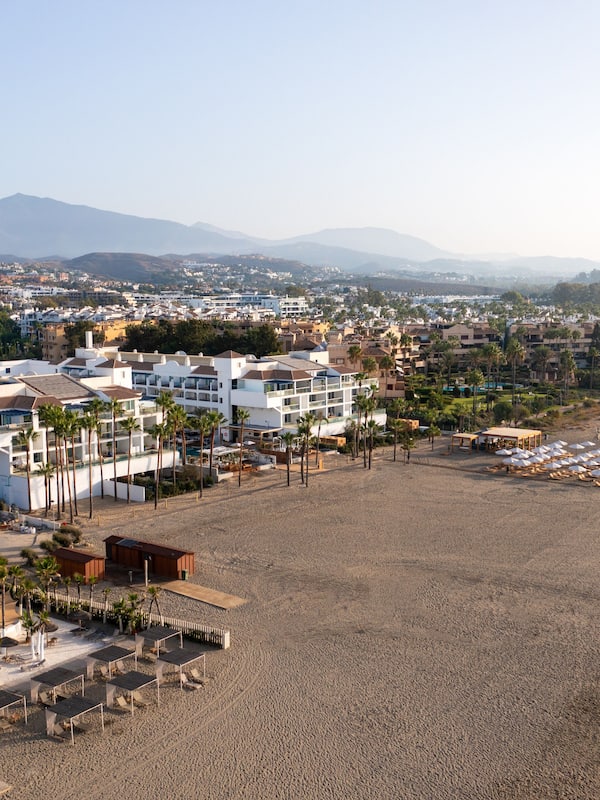 Enjoy stunning ocean views and relax on the beach with sun loungers and umbrellas.