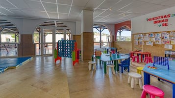 Children can play and create amidst colorful play structures and artwork.
