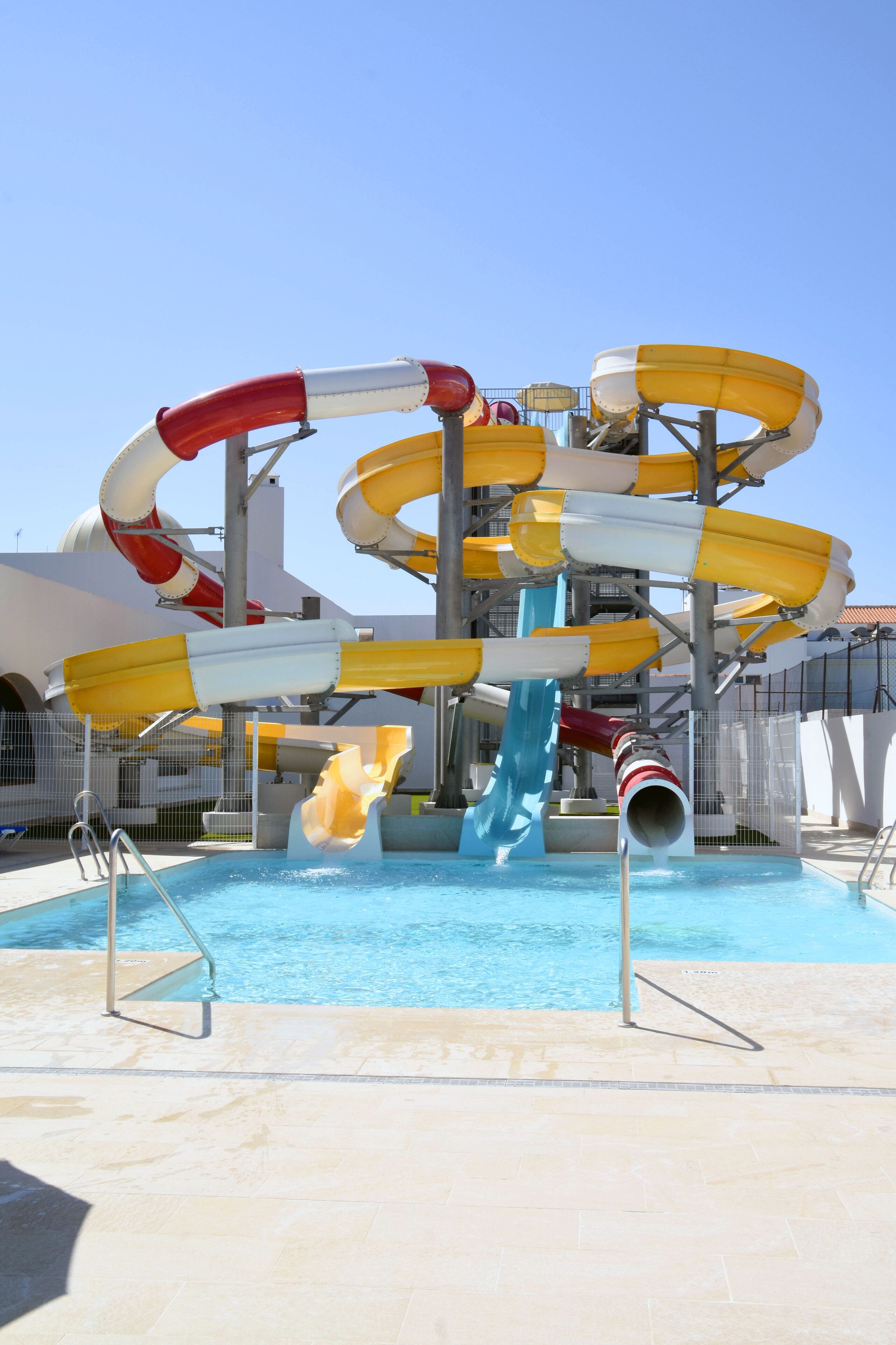 Un parque acuático con múltiples toboganes y una piscina.