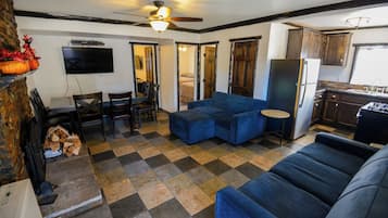 Deluxe Cabin, 2 Bedrooms, Fireplace | Living area | 32-inch flat-screen TV with cable channels, fireplace