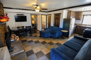 Deluxe huisje, 2 slaapkamers, open haard | Woonruimte | Een 32-inch flatscreentelevisie met kabelzenders en een open haard