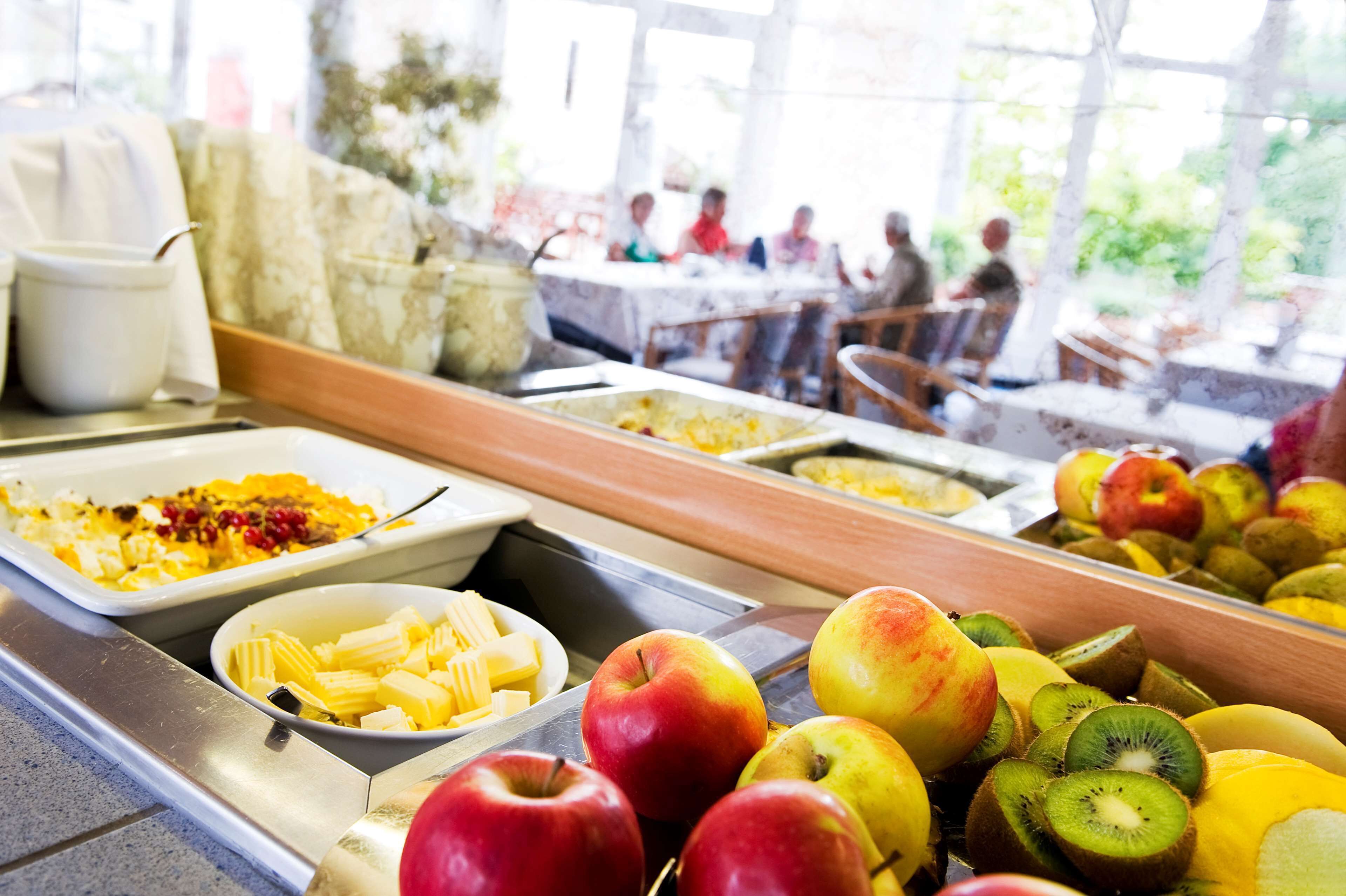 A buffet with various fruits and dishes.