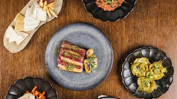 A variety of dishes arranged on a wooden table.