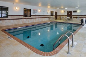 A swimming pool with a tiled edge, a lifeguard chair, and a sign detailing pool rules. - Holiday Inn Express & Suites Cherry by IHG (Omaha)