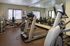 A gym with treadmills, weight machines, and dumbbells. - Holiday Inn Express & Suites Cherry by IHG (Omaha)