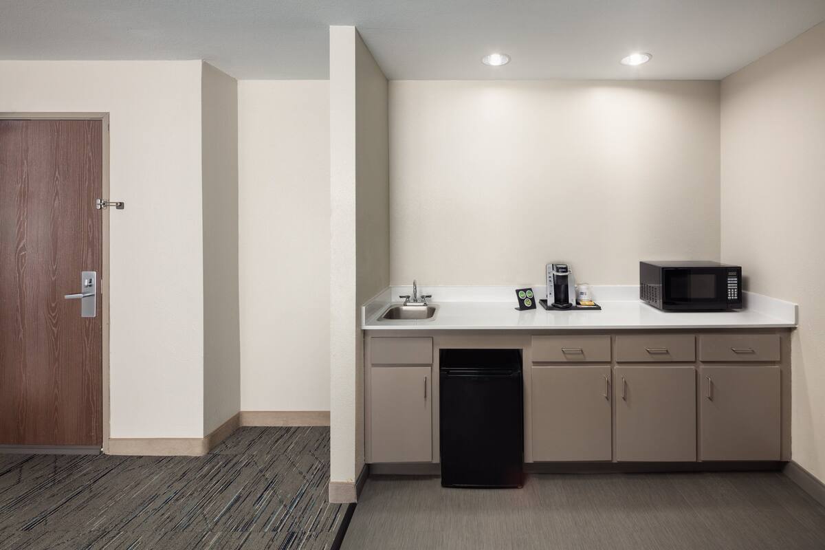 premium suite, 1 king bed, jetted tub | 1 bedroom, desk, laptop workspace, blackout curtains