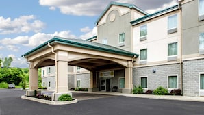 A hotel with a covered entrance, multiple windows, and a sign that reads "Gold Award Winner."