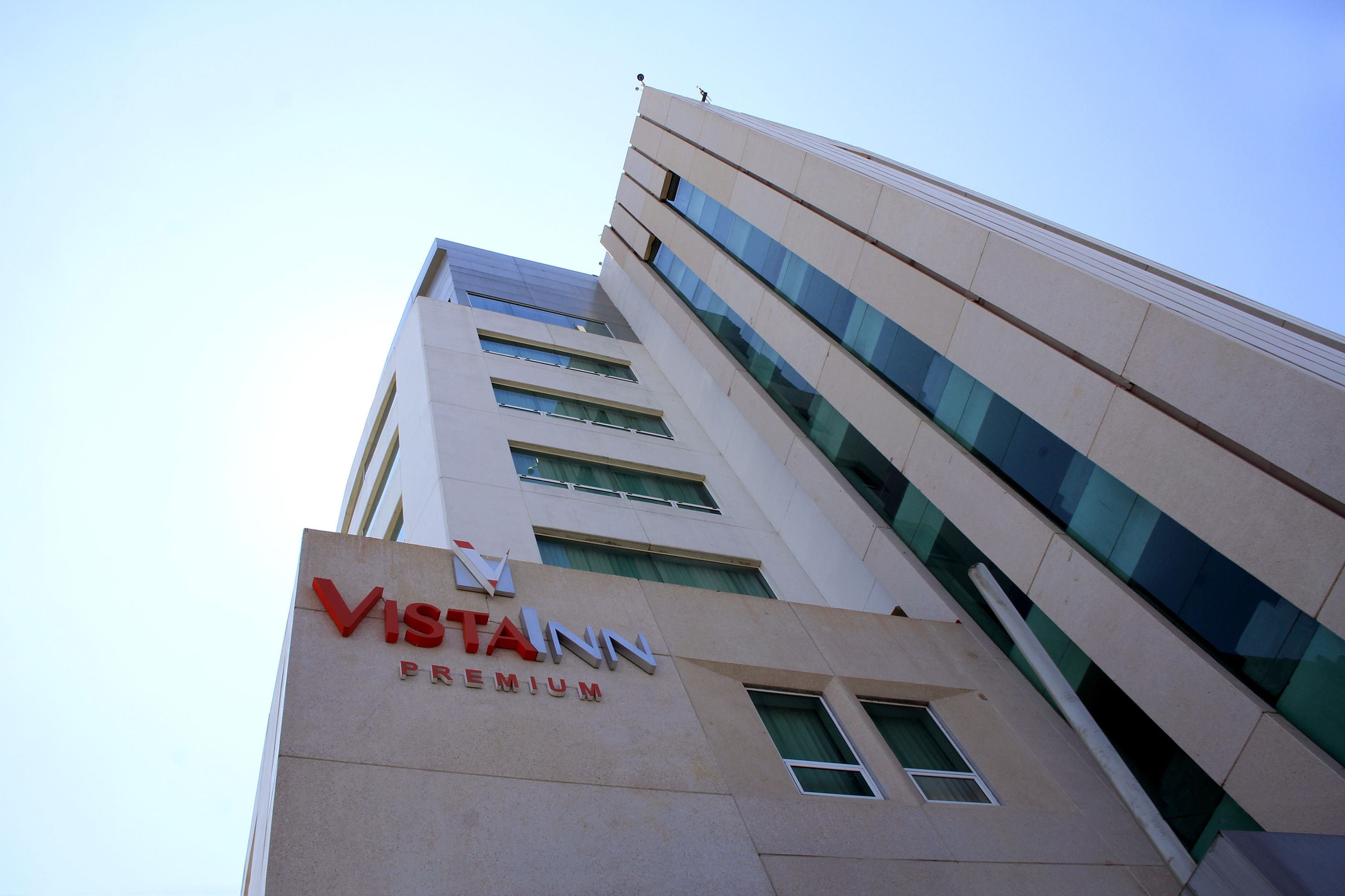 A tall building with the sign "Vistain Premium" on its facade.