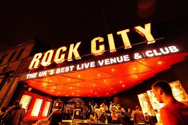 The exterior of Rock City, a live venue and club with a prominent sign and a crowd of people.