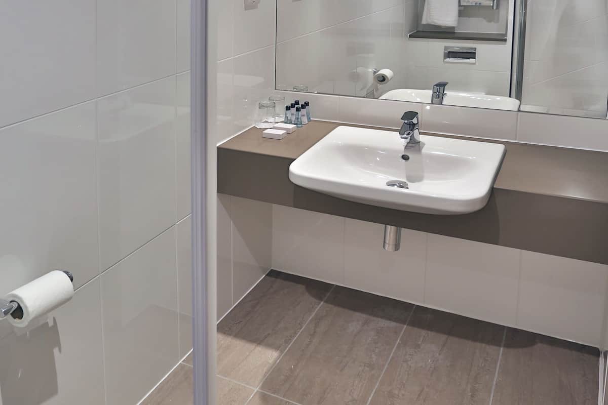 bathtub, hair dryer, bathrobes, towels