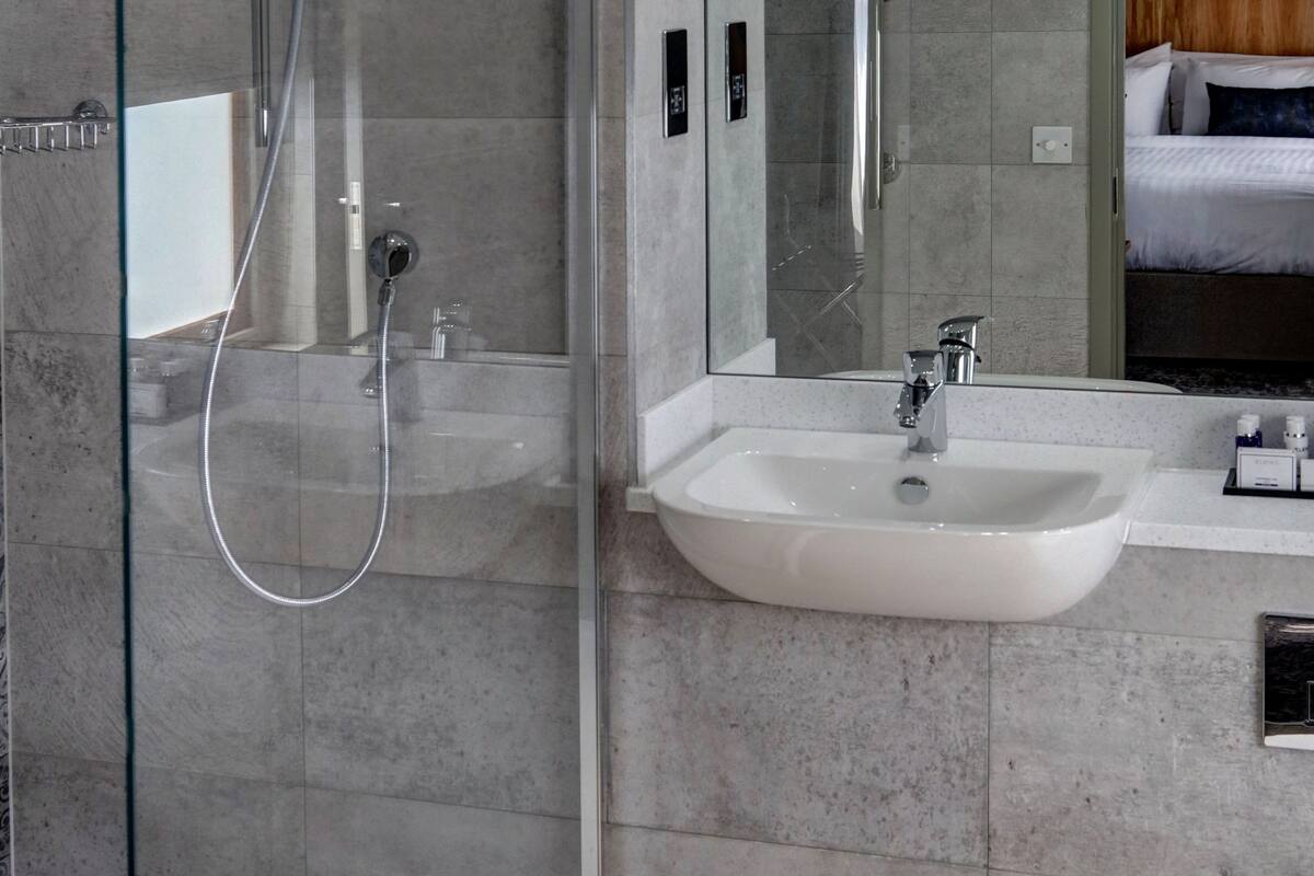 bathtub, hair dryer, bathrobes, towels