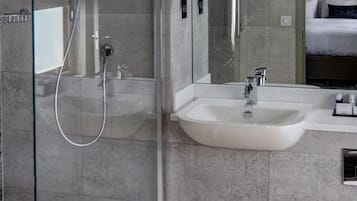 Bathtub, hair dryer, bathrobes, towels