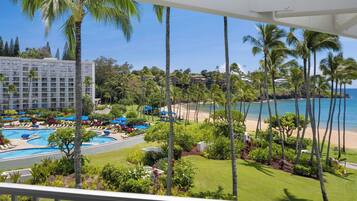 A resort with a pool, beach, and ocean view.