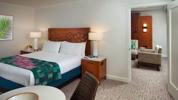 Une chambre d’hôtel comprenant un lit, des tables de chevet, une chaise, une petite table et un miroir.
