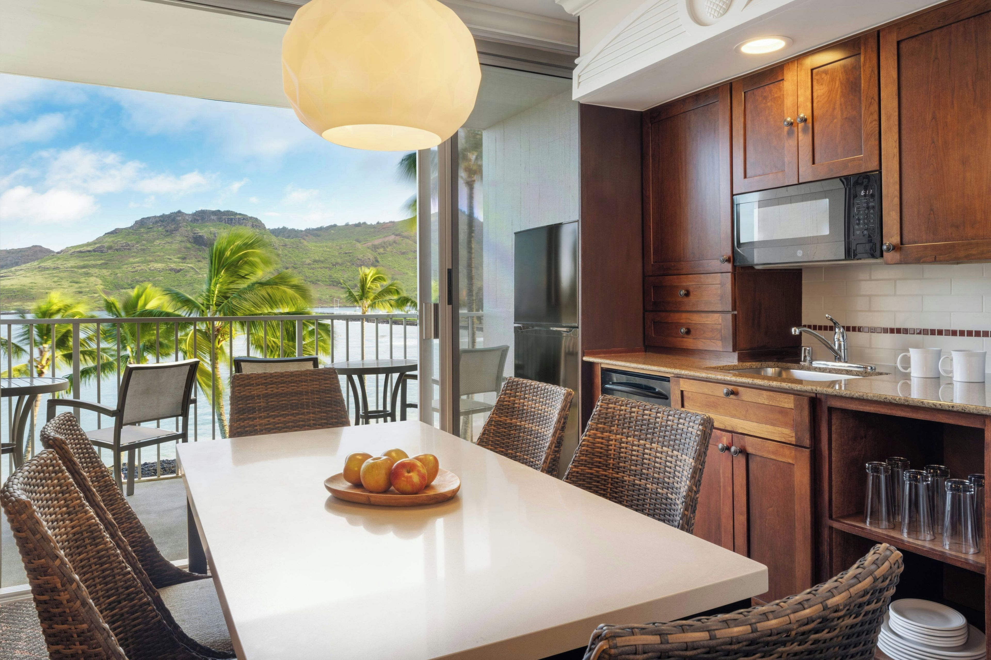 A modern kitchen with a view of a mountainous landscape.