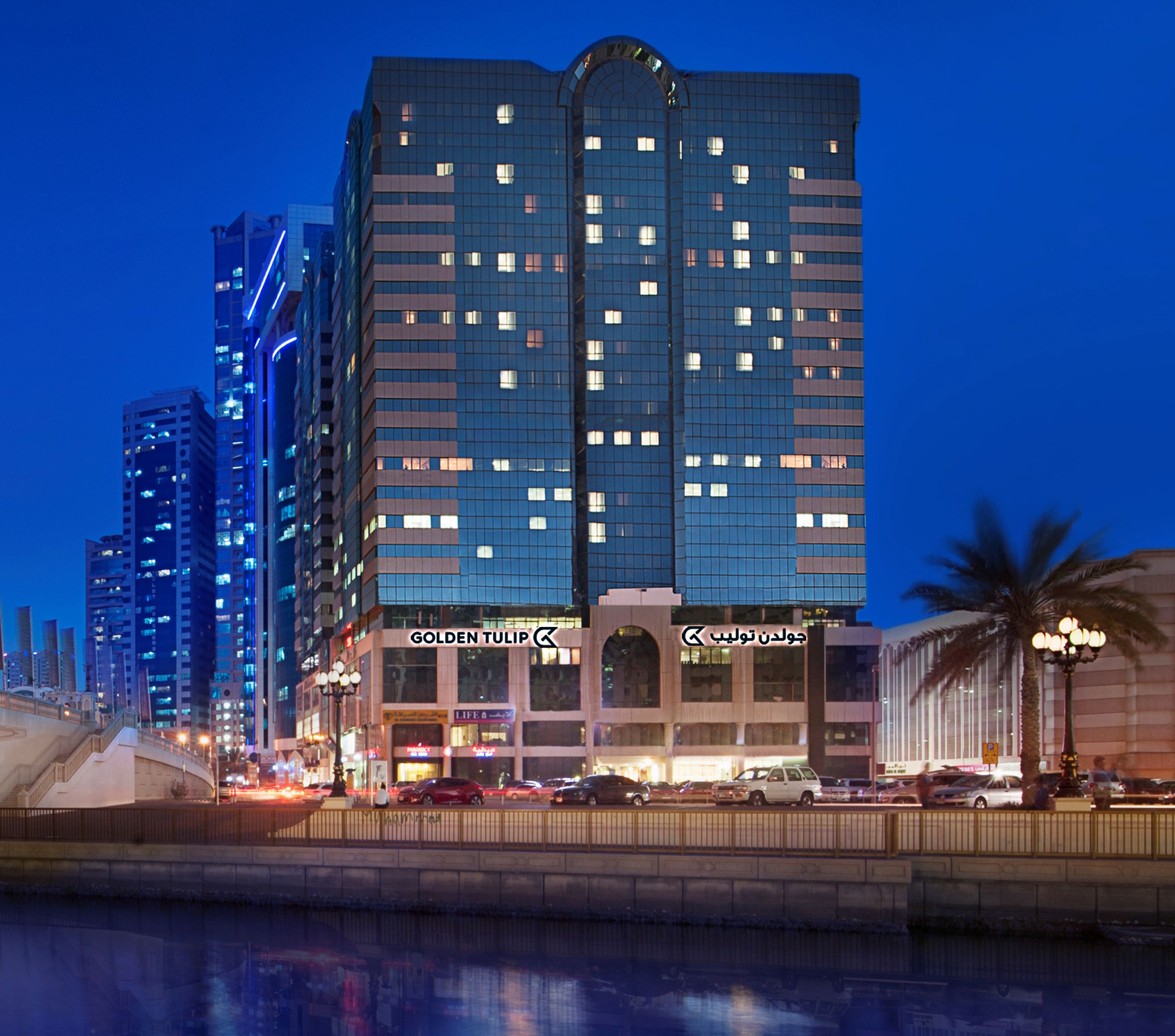 A high-rise hotel with multiple floors, large windows, and a prominent entrance.